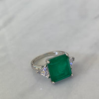 Sterling silver Emerald green ring with triangle cut side stones